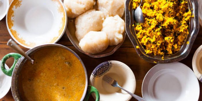 above view of kitchen table with traditional sauces and african food with natural light